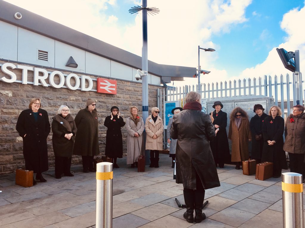 Singers standing side by side at Strood station
